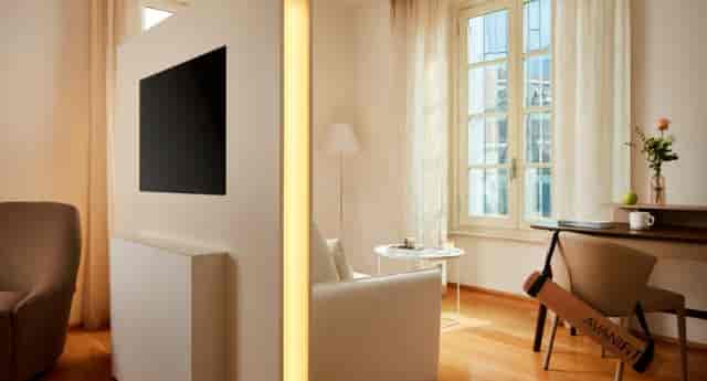 Avani Palazzo Moscova Milan hotel suite with workspace for bleisure and business travel.