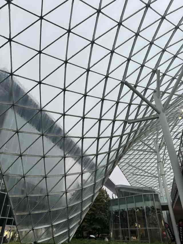 Modern Fiera Milano atrium with glass grid roof for upscale corporate events and exhibitions.