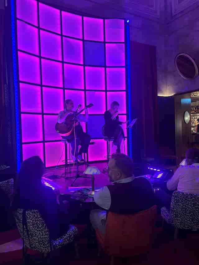 Rumore bar interior with vibrant LED stage lighting for corporate mixer and evening reception.
