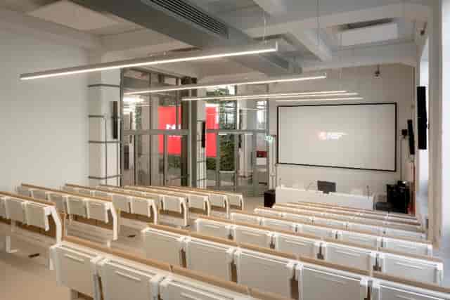 Modern lecture hall with tiered seating for corporate training and speaker presentations.