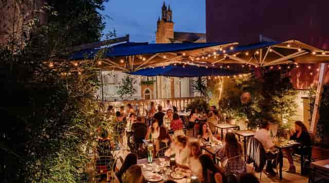 Atmospheric restaurant terrace with string lighting for romantic wedding or private event venue.