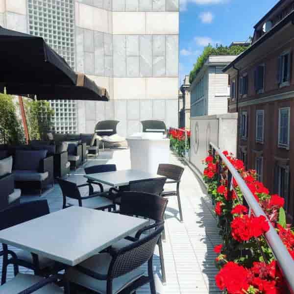 Terrazza Aria rooftop lounge with floral backdrop for upscale cocktail receptions and events.