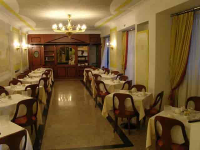 Formal banquet dining room at Hotel Marconi for intimate corporate events or wedding receptions.