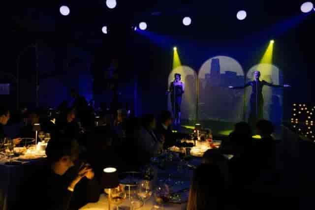 PYT Milano immersive dinner show with scenic projection lighting for exclusive event dining.