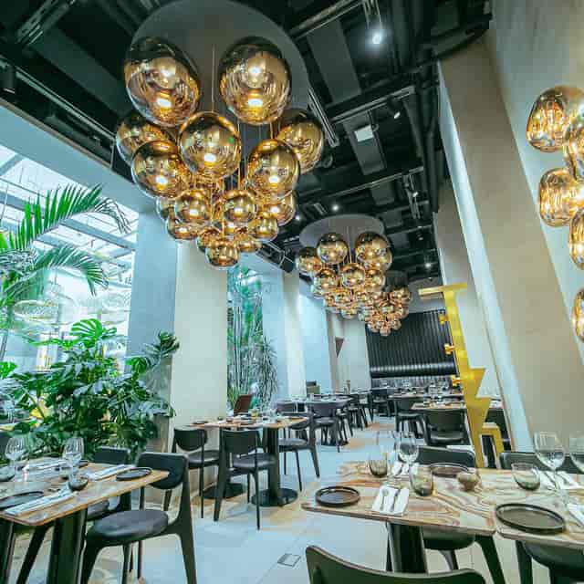Modern restaurant dining space with sculptural lighting for corporate events and VIP receptions.