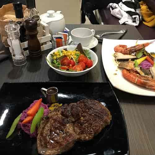 Premium steak and seafood plated lunch for corporate workshops and executive networking events.