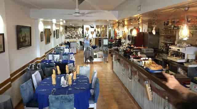 Narrow banquet venue for social dinners and event catering, featuring round and rectangular seating.