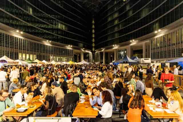 Outdoor banquet seating at C.I.B.O. Milano street food festival workshop area.