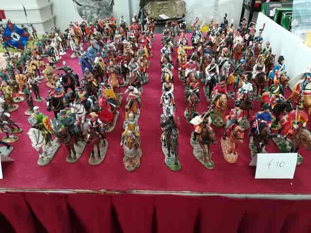 Crowded trade show display at Parco Esposizioni Novegro, dense collector expo table.