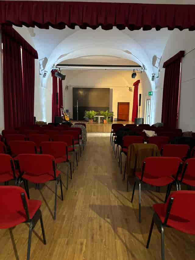 Auditorium at I Chiostri di San Barnaba with vaulted ceilings for corporate events and conferences.