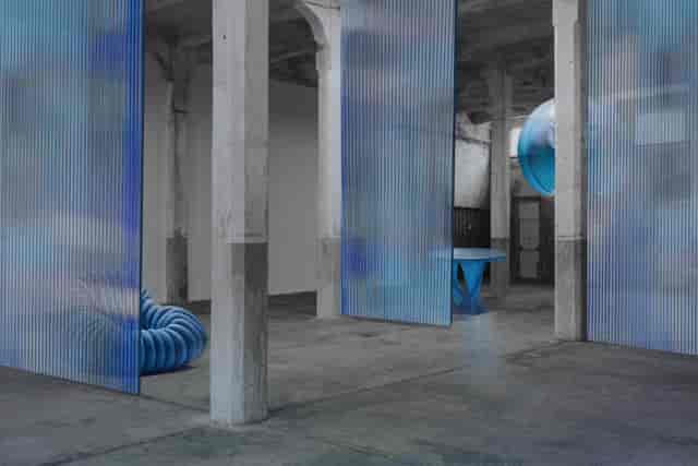 Exhibition Hub at LAMPO industrial venue featuring modular fluted panels for event breakout spaces.