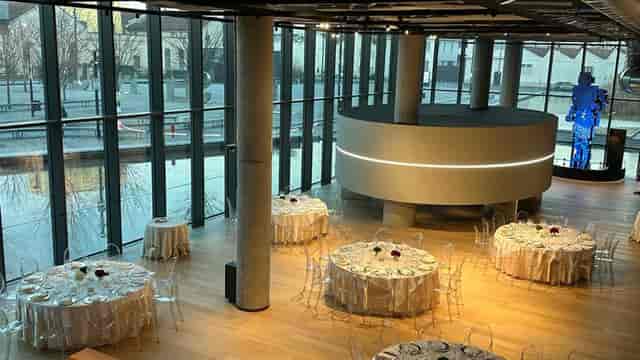 Modern banquet venue at STEP FuturAbility District with circular design and ghost chairs.