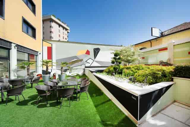 Rooftop terrace with artificial turf for corporate networking and breakout events.