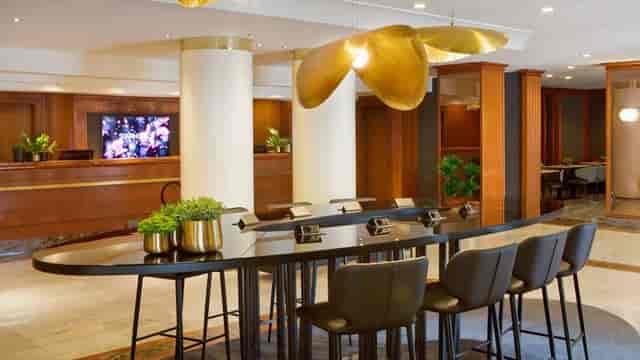 Communal workspace with statement lighting at Starhotels Tourist for business events and meetings.