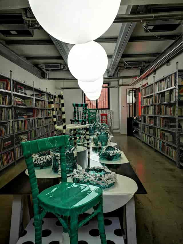 Artistic showroom breakout space with industrial shelving for creative workshops and design events.