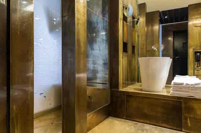 Luxury hotel meeting room with brass-toned minimalist design for upscale corporate events.