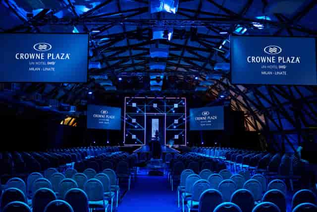 Theater-style stage at Il Giardino Milan with industrial architecture for corporate events.