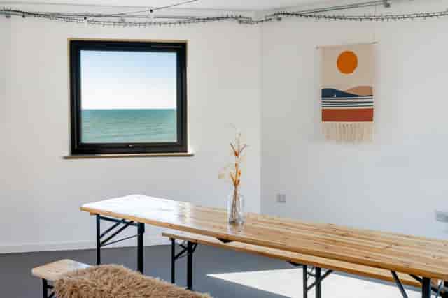 Minimalist breakout room at The Studio Brighton with seaside views for offsites and workshops.