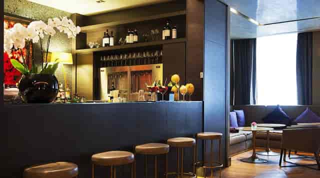 Sleek lounge bar with soft seating, ideal for VIP hosting and conference networking events.