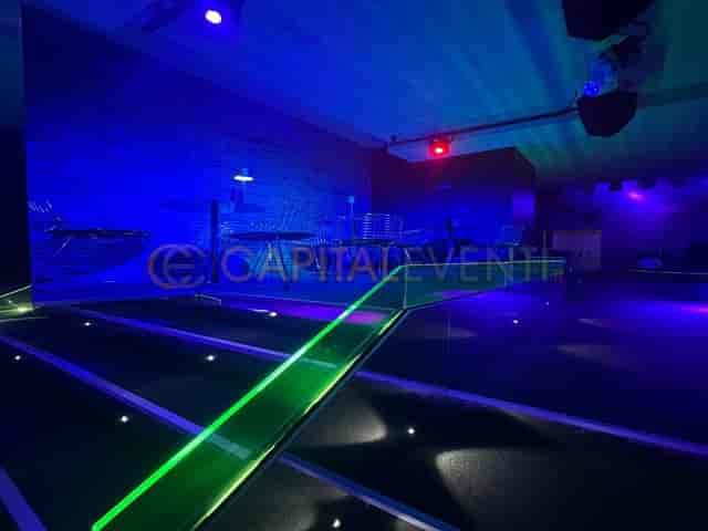 Modern cocktail bar with blue ambient lighting for exclusive nightlife and corporate events.