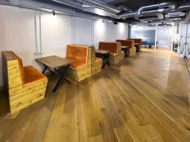 Industrial-chic breakout booths in The Lower Deck, ideal for networking and coworking events.