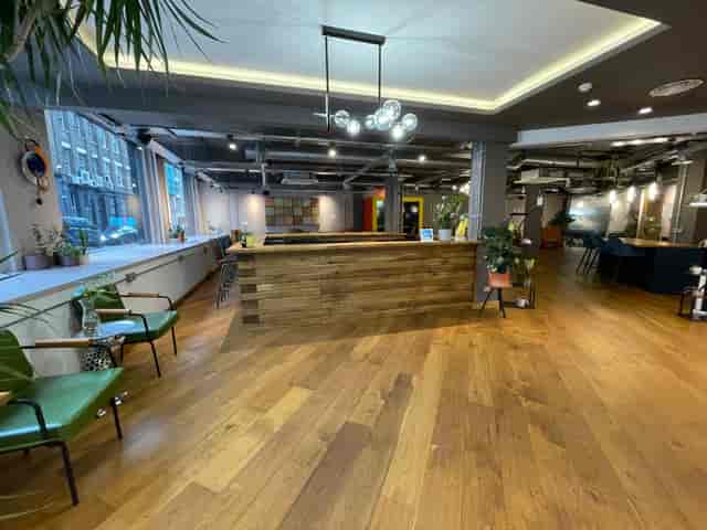 Industrial breakout space with wooden bar for networking events and co-working.
