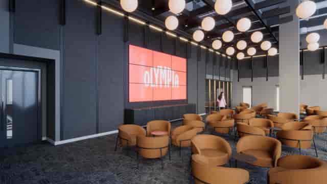 Modern ICC Olympia lounge with branded video wall for corporate events and networking.