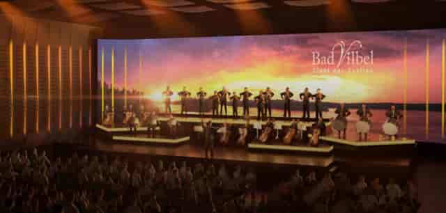 Orchestral performance on stage with LED backdrop for corporate event venue hire.