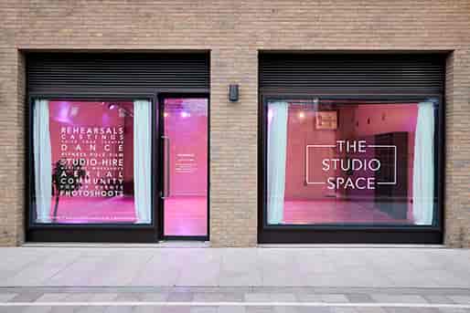 Modern event venue with large windows, perfect for rehearsals and community gatherings.
