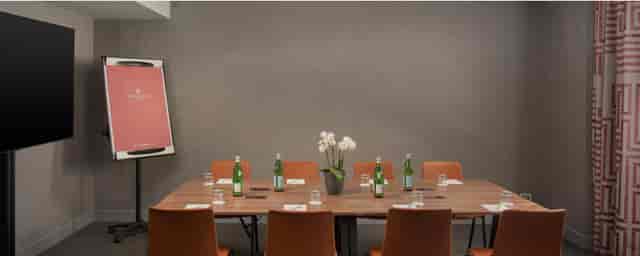 Meeting room with rectangular table, ideal for corporate meetings and workshops.