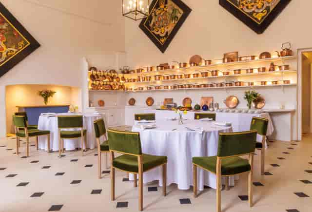 The Old Kitchen at Badminton Estate: copper cookware and green velvet for intimate banquet events.