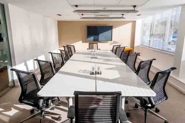 Boardroom meeting room with ergonomic chairs, ideal for business conferences and corporate events.