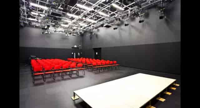 University of Salford black-box studio with stage lighting for professional events and conferences.