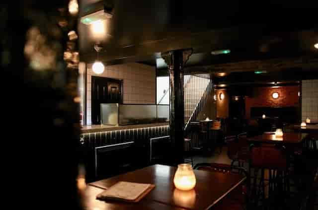 Industrial lounge with moody lighting for networking and post-conference drinks reception.