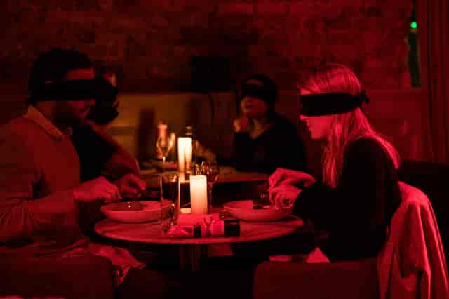 Atmospheric dining event with forced perspective design for sensory experiential marketing.