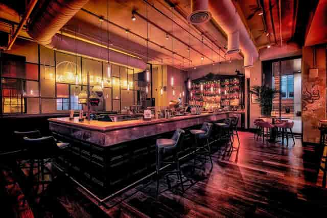 Industrial-chic bar at The Alchemist for corporate networking and VIP event hosting.