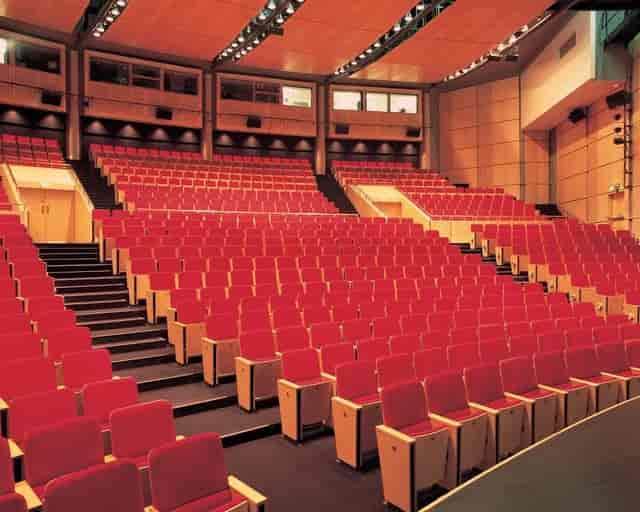 Tiered auditorium at Manchester Meeting Place for professional plenary sessions and keynotes.