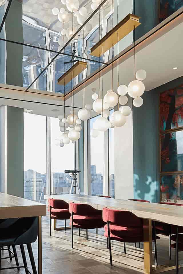 Modern Angel Gardens breakout space with bubble chandelier for board meetings and VIP receptions.