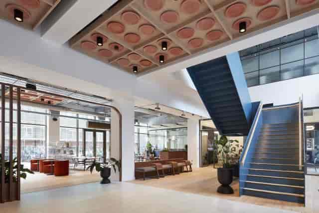 Modern atrium at Contact Manchester with architectural staircase for corporate networking events.