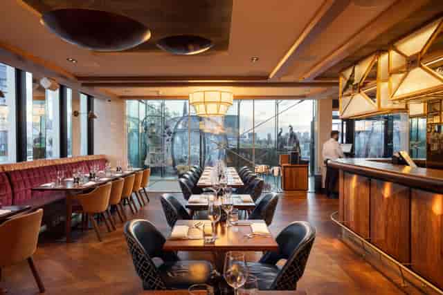 Luxury hotel bar with skyline view for corporate networking and executive dinner events.