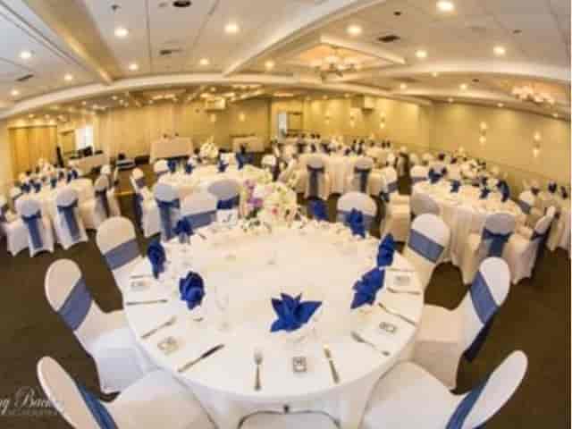Banquet-style Terrace event space with blue chair sashes for weddings or corporate galas.