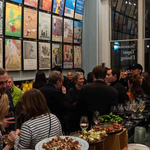 Sophisticated networking reception at Royal Academy of Arts Poster Bar with vertical art displays.