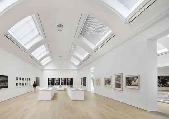 Elegant gallery event venue with vaulted ceilings for VIP networking and cocktail receptions.