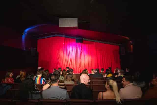 Cozy performance venue with red curtains, ideal for events and networking at GRUB MCR.