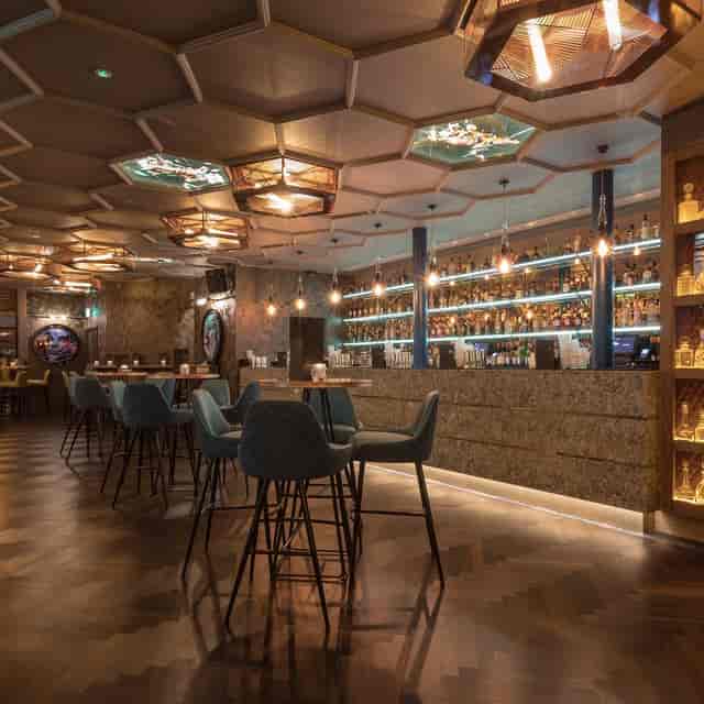 Stylish cocktail bar in Dirty Martini Manchester with illuminated spirit shelf, perfect for events.