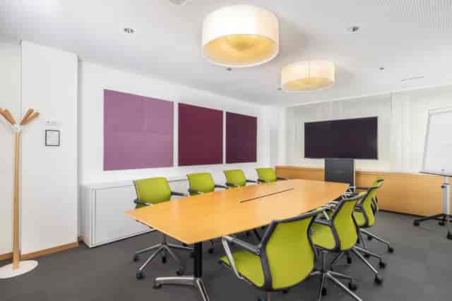 Boardroom-style meeting room with ergonomic seating for corporate events and business seminars.