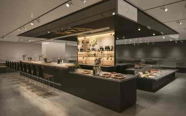 Contemporary trade show booth with bar seating for VIP networking and product degustation events.