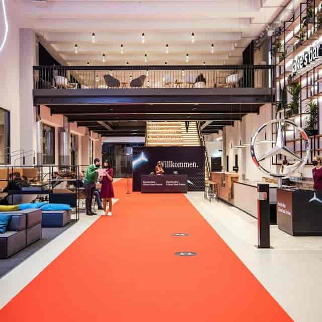 Modern industrial-chic event venue with registration desk for corporate reception and brand activation.