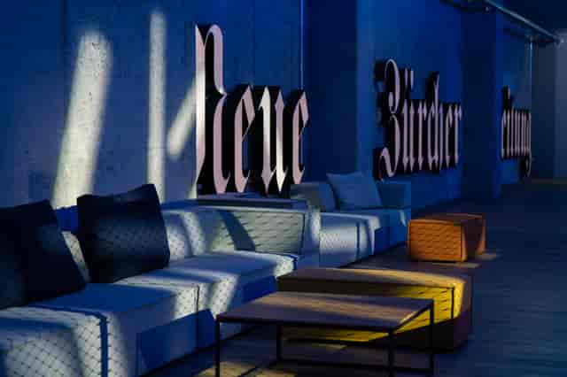 Industrial-chic JED Events lounge with modular seating for VIP networking and corporate sessions.