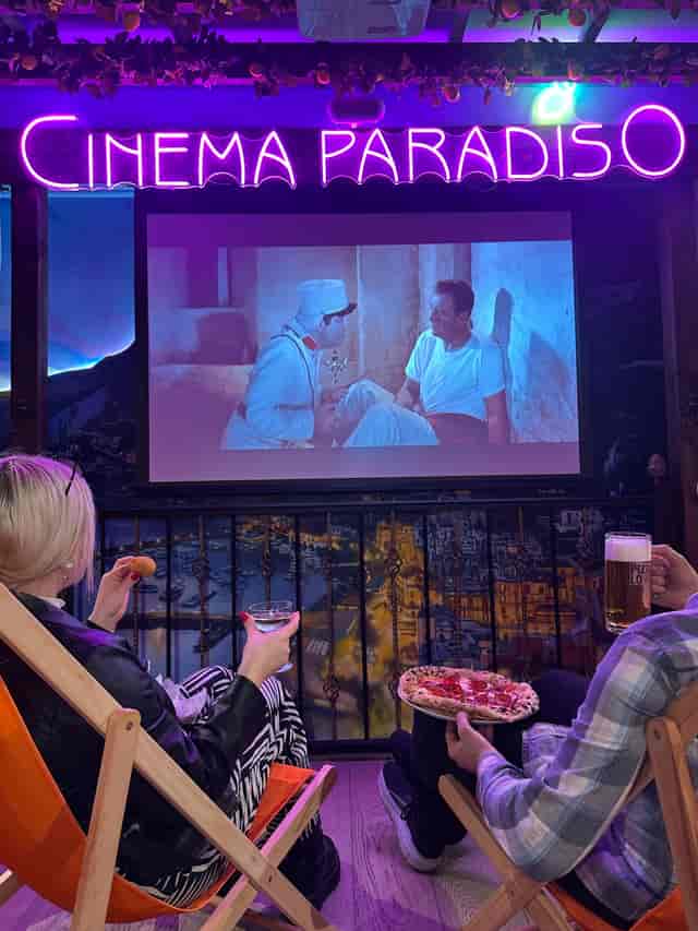 Cinema Paradiso neon sign at Pizza Pilgrims Chelsea for private screenings and micro-events.